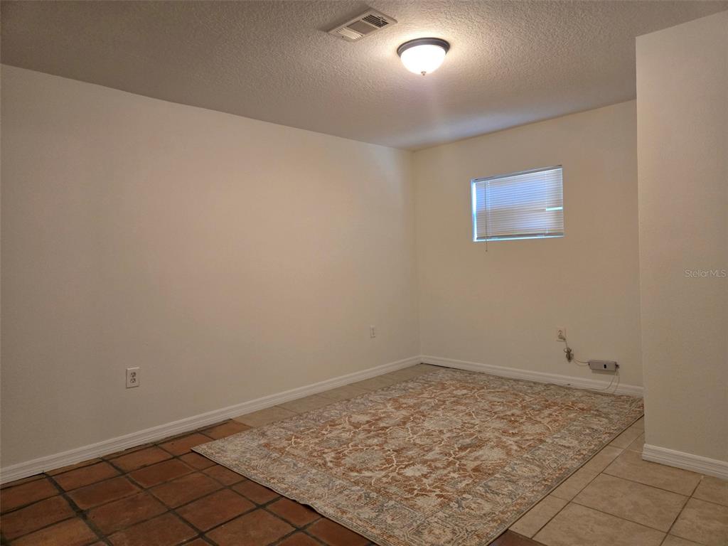 2115 5th Street, Unit 2 Sarasota, FL 34237 - Photo 18 of 22 an empty room with a bench