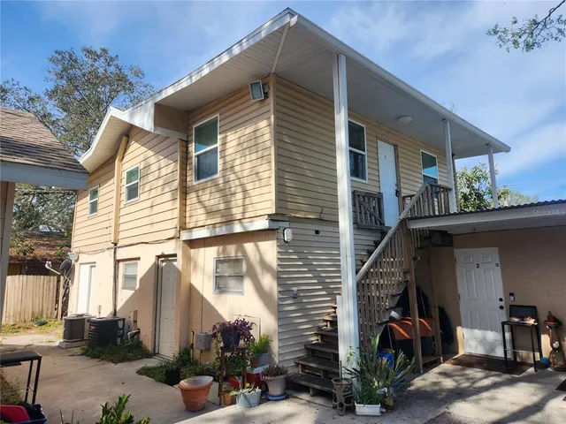 a view of a house with a garage and balcony