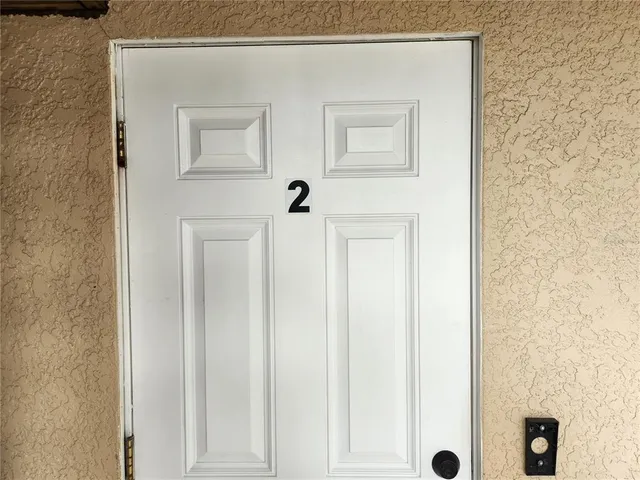 a kitchen with a sink a refrigerator and cabinets