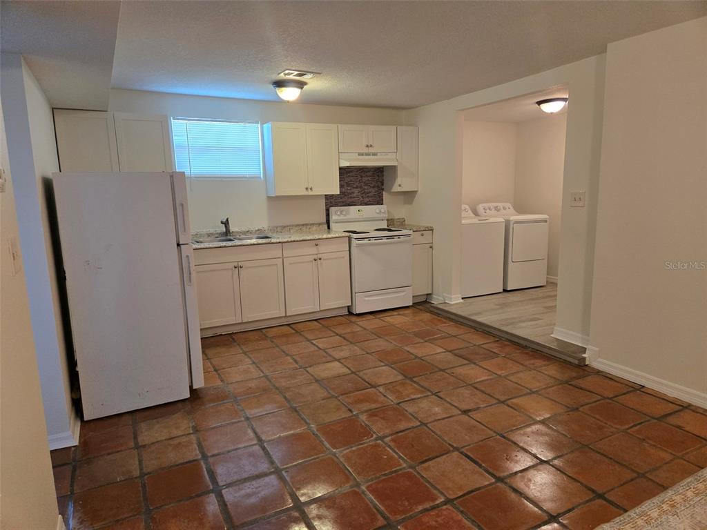 2115 5th Street, Unit 2 Sarasota, FL 34237 - Photo 4 of 22 a kitchen with a sink a refrigerator and cabinets