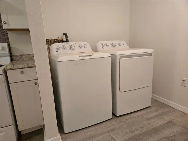 a kitchen with a refrigerator a stove top oven and cabinets