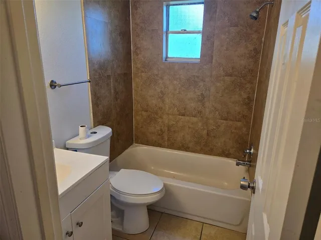 a view of a small space with wooden floor and a window