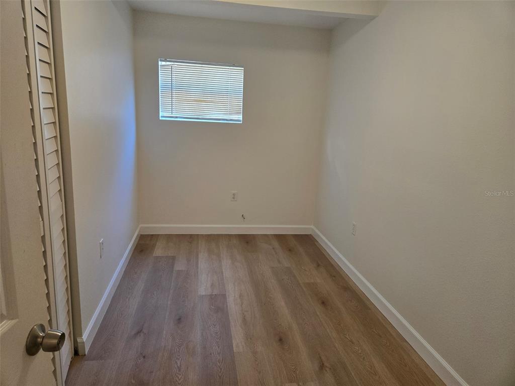2115 5th Street, Unit 2 Sarasota, FL 34237 - Photo 8 of 22 a view of a small space with wooden floor and a window