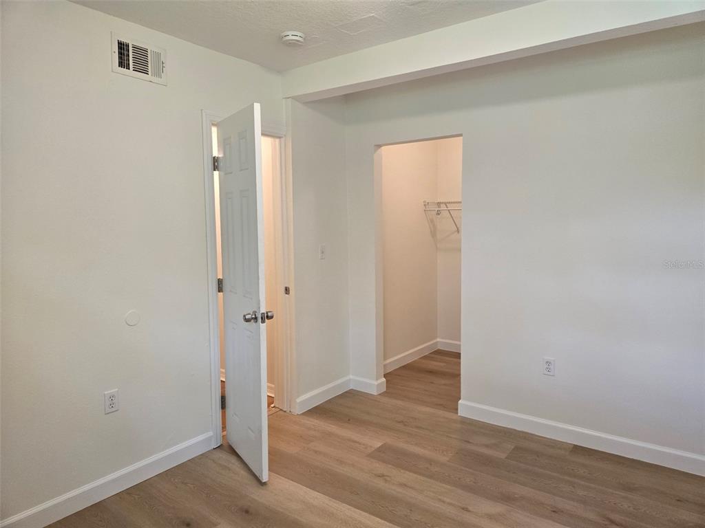 2115 5th Street, Unit 2 Sarasota, FL 34237 - Photo 10 of 22 an empty room with wooden floor and closet
