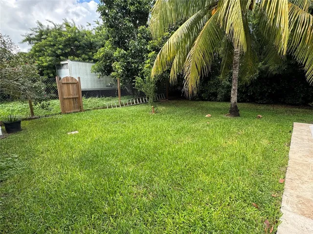 a backyard of a house with lots of green space