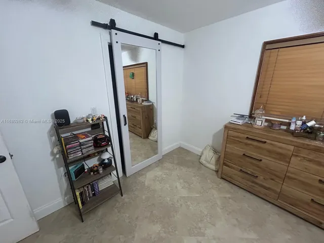 a bedroom with a bed and a chair