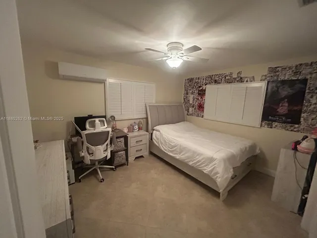 a bedroom with a bed and a walk in closet