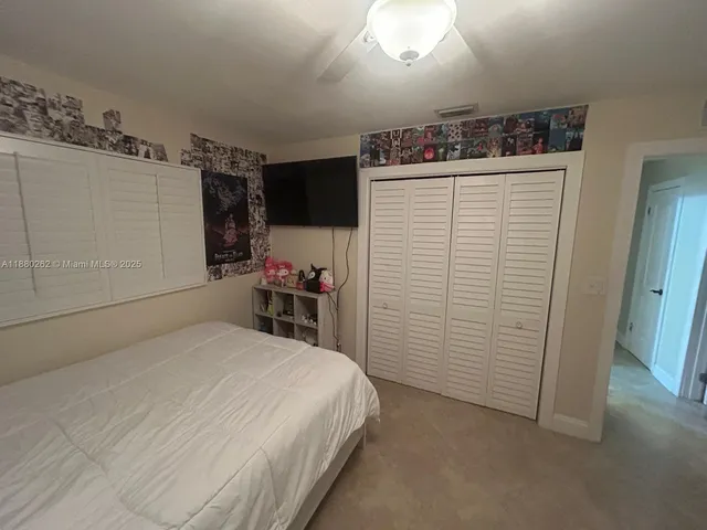 a bathroom with a granite countertop sink a toilet and mirror