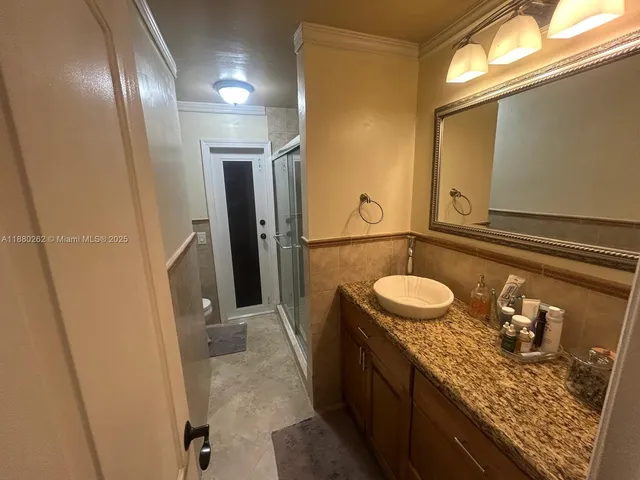 a bedroom with a bed and flat screen tv