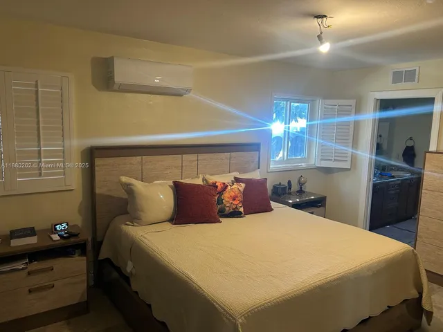 a living room with furniture and a refrigerator