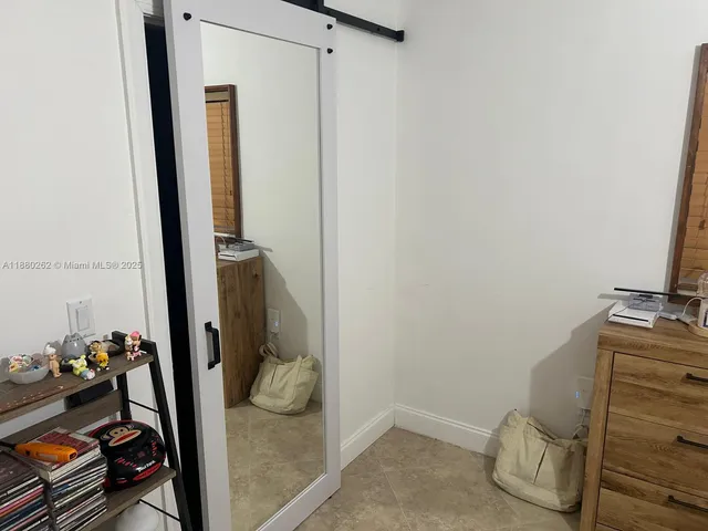 a bedroom with furniture and a flat screen tv