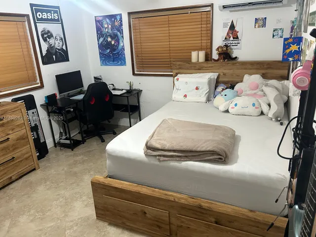 a view of a livingroom with lounge chair and a floor to ceiling window