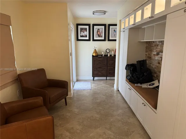 a living room with furniture and a walk in closet