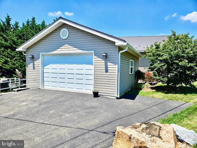 201 St Paul Street Boonsboro, MD 21713 - Photo 5 of 6 Charming garage with lush greenery.