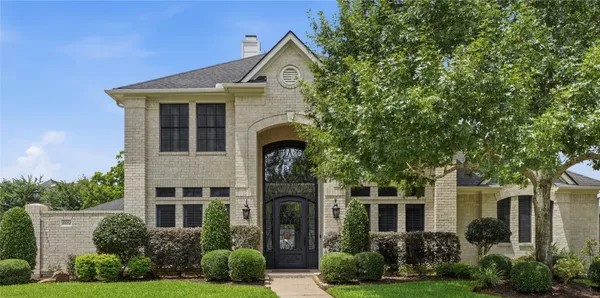 front view of a house with a garden