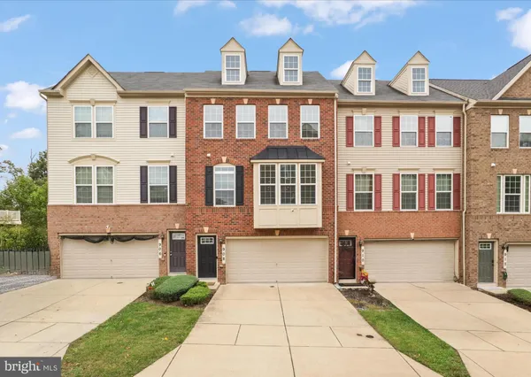 a front view of a residential apartment building with a yard