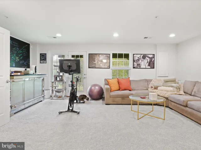 a work room with furniture and a floor to ceiling window