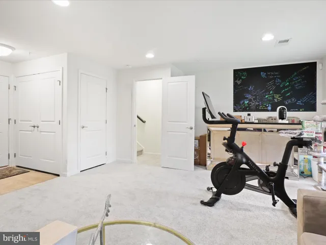 a bathroom with a sink a toilet a mirror and shower