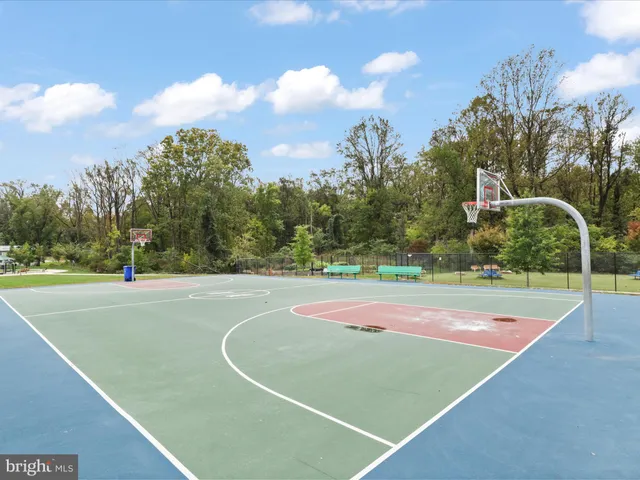 a swimming pool with outdoor seating and garden