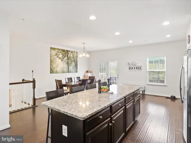 a open kitchen with stainless steel appliances granite countertop a granite counter tops and a view of living room