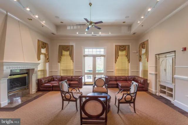 a living room with furniture a fireplace and a chandelier