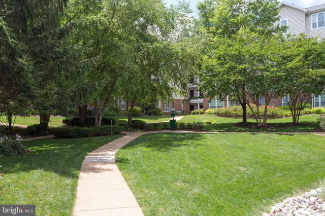 a front view of a building with a garden