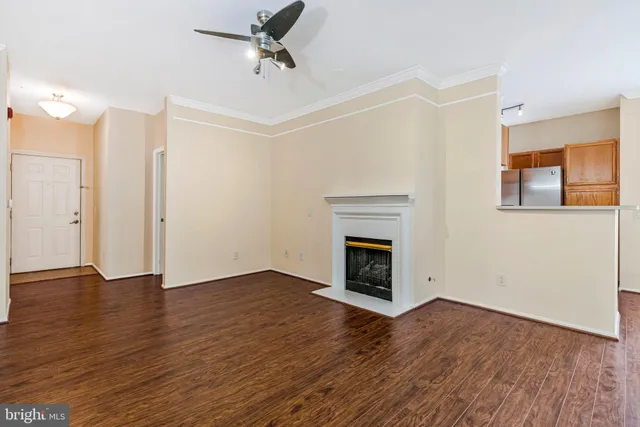 a view of empty room with wooden floor and fireplace