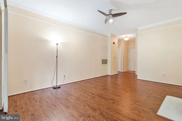 a view of an empty room with a ceiling fan