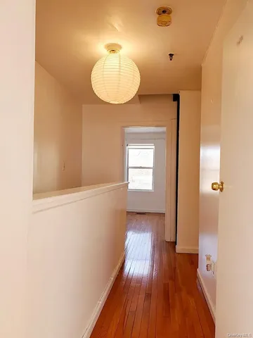 a view of a room with wooden floor staircase and a bathroom