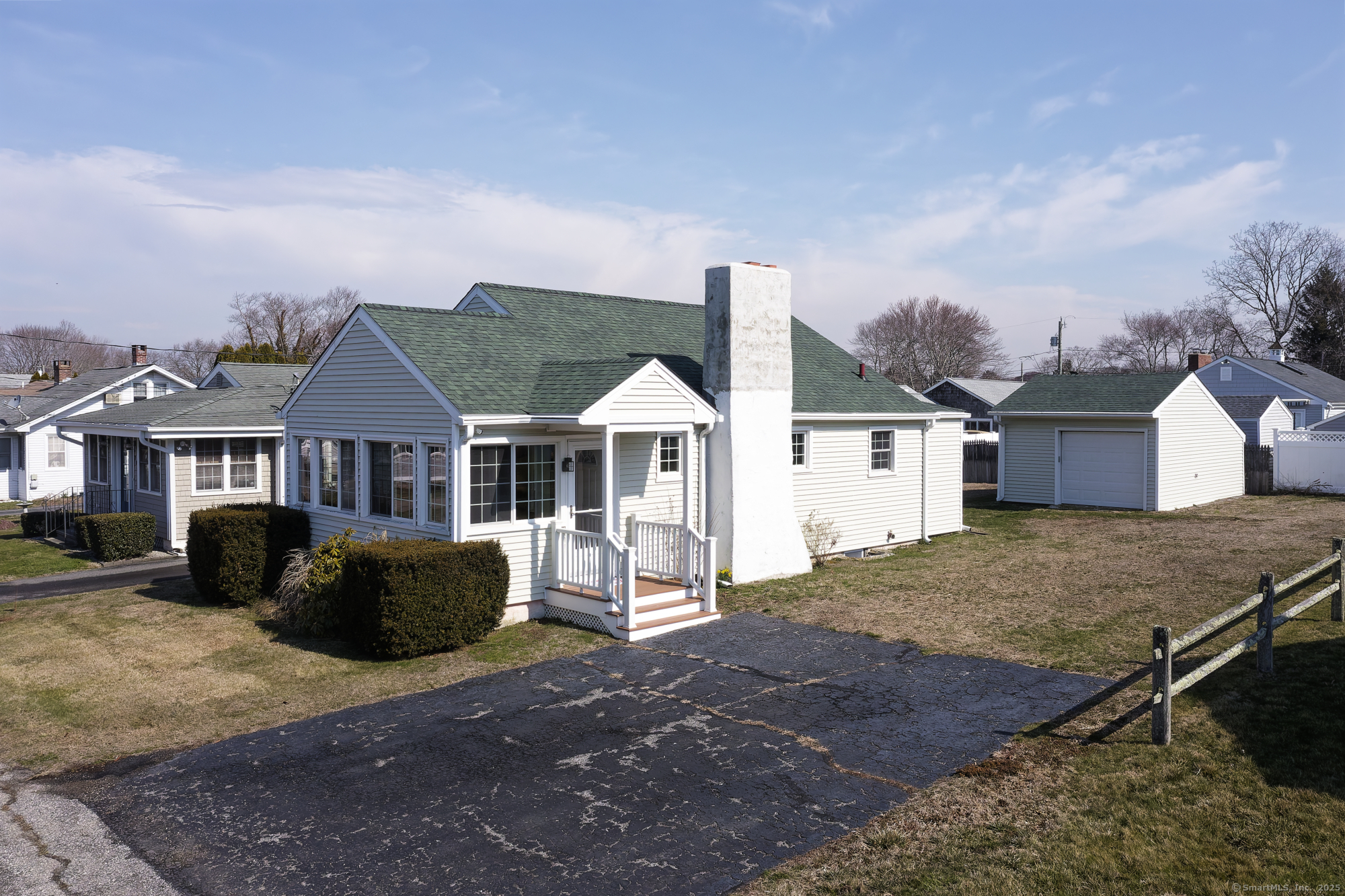 22 Gates Road Old Saybrook, CT 06475 - Photo 1 of 1 a front view of a house with a garden