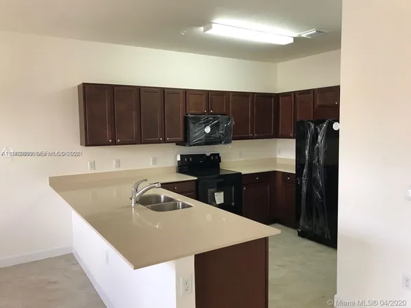 a kitchen with a sink and cabinets