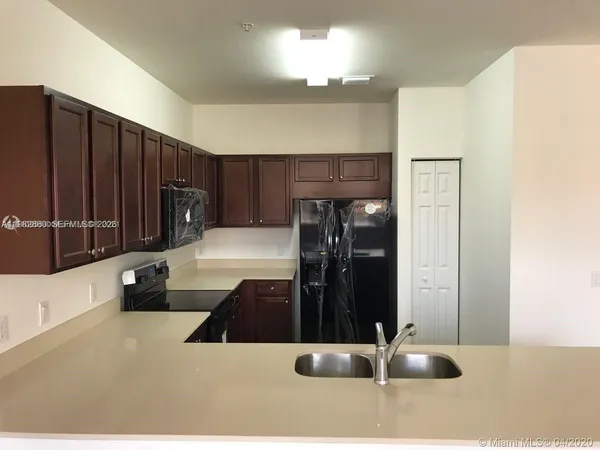 a kitchen with a sink and cabinets