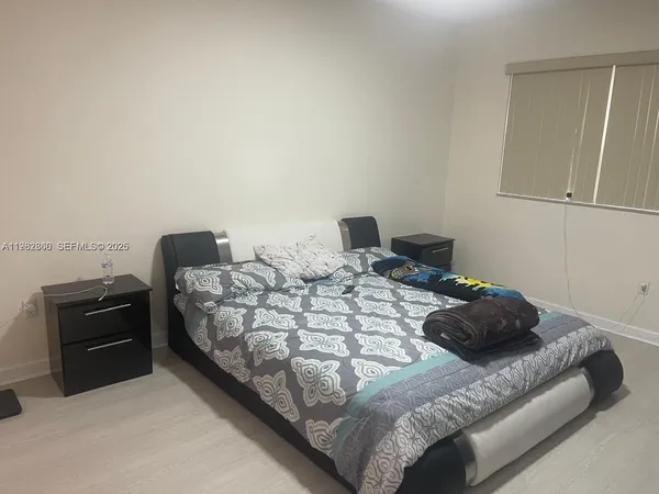 a bedroom with a bed and chair