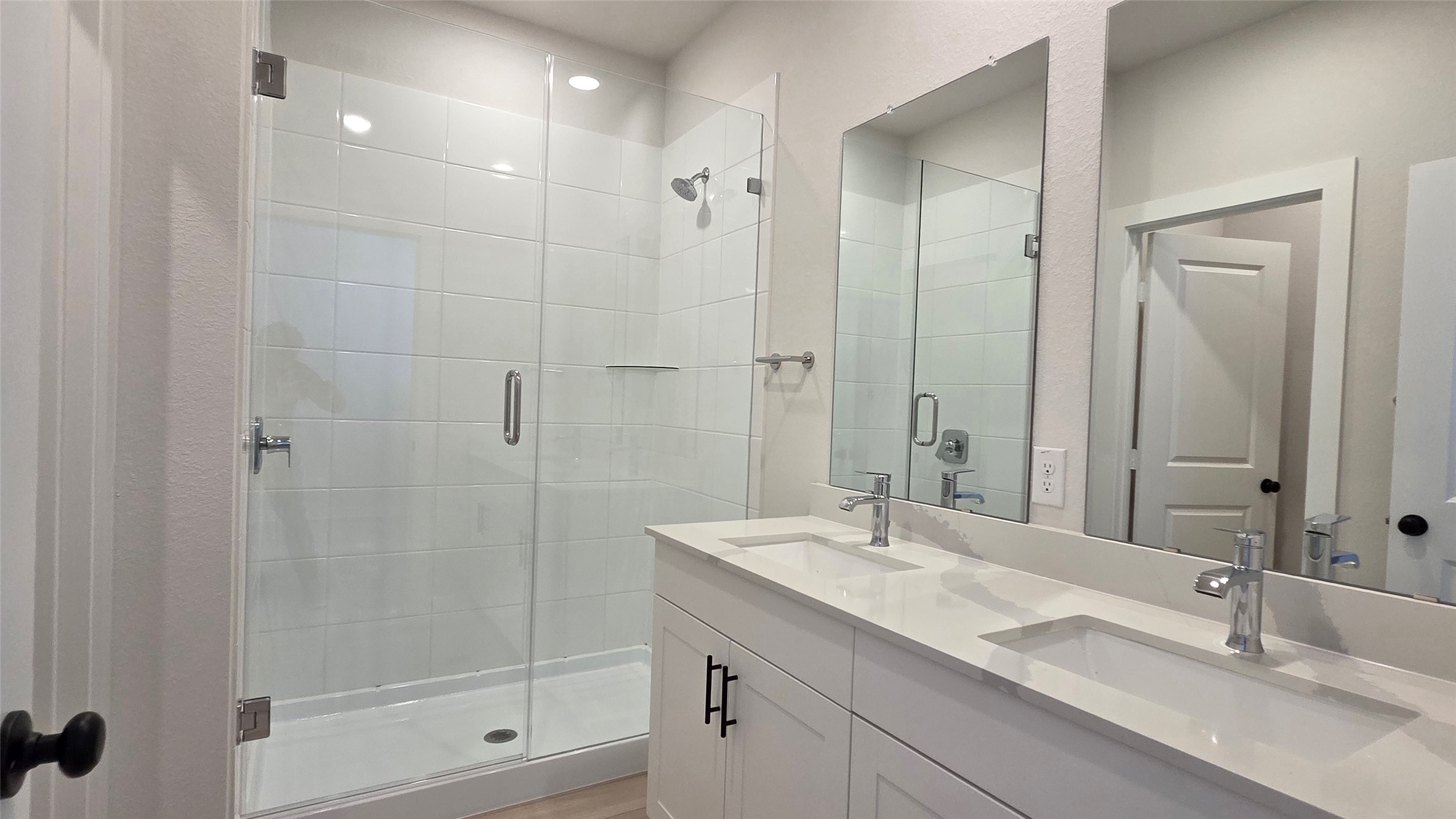 8107 Wilder Road Austin, TX 78736 - Photo 19 of 35 A well-appointed bathroom with a spacious dual vanity and a pristine glass-enclosed shower.
