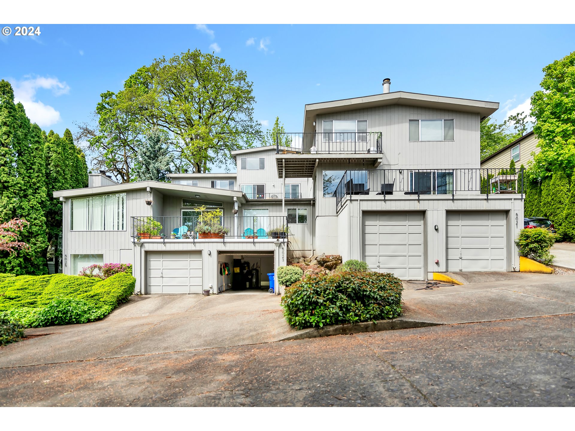5013 Southwest View Point Terrace Portland, OR 97239 - Photo 1 of 44 a front view of a house with a yard