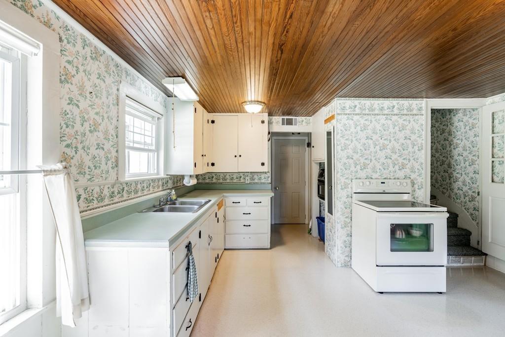 11 Dingley Dell Road Brimfield, MA 01010 - Photo 19 of 42 a kitchen with white cabinets and white appliances