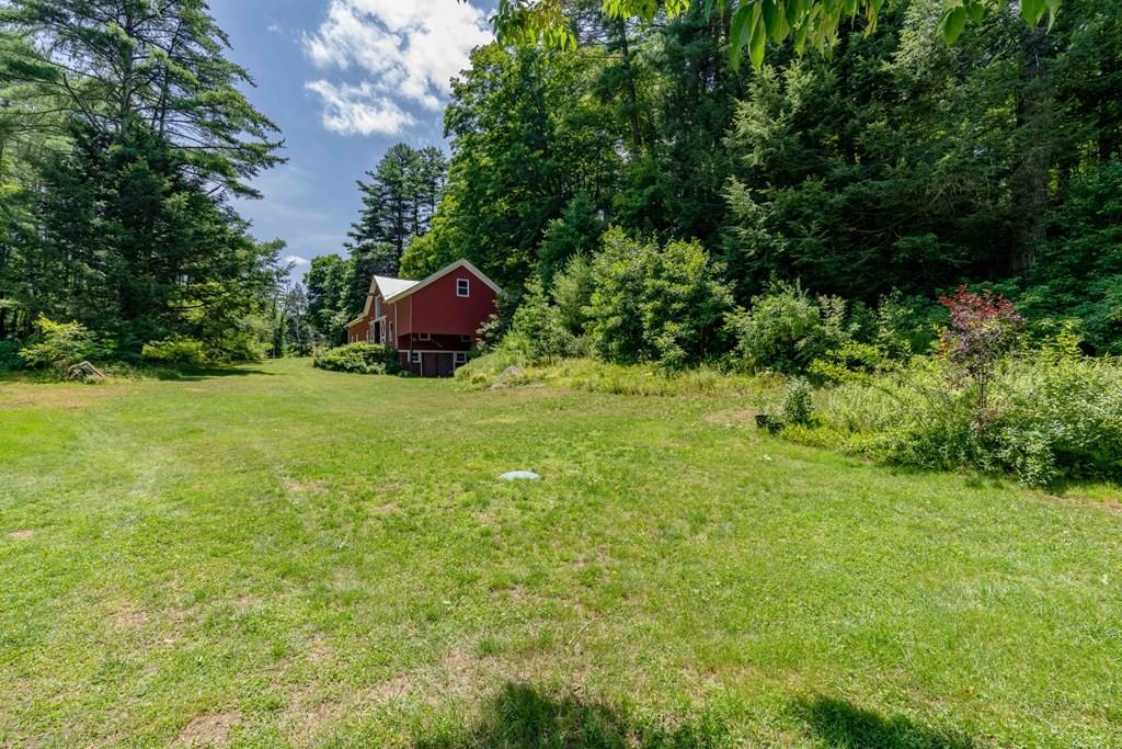 11 Dingley Dell Road Brimfield, MA 01010 - Photo 40 of 42 a backyard of a house with yard and trampoline