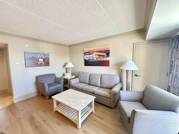a bedroom with two beds and painting on the wall
