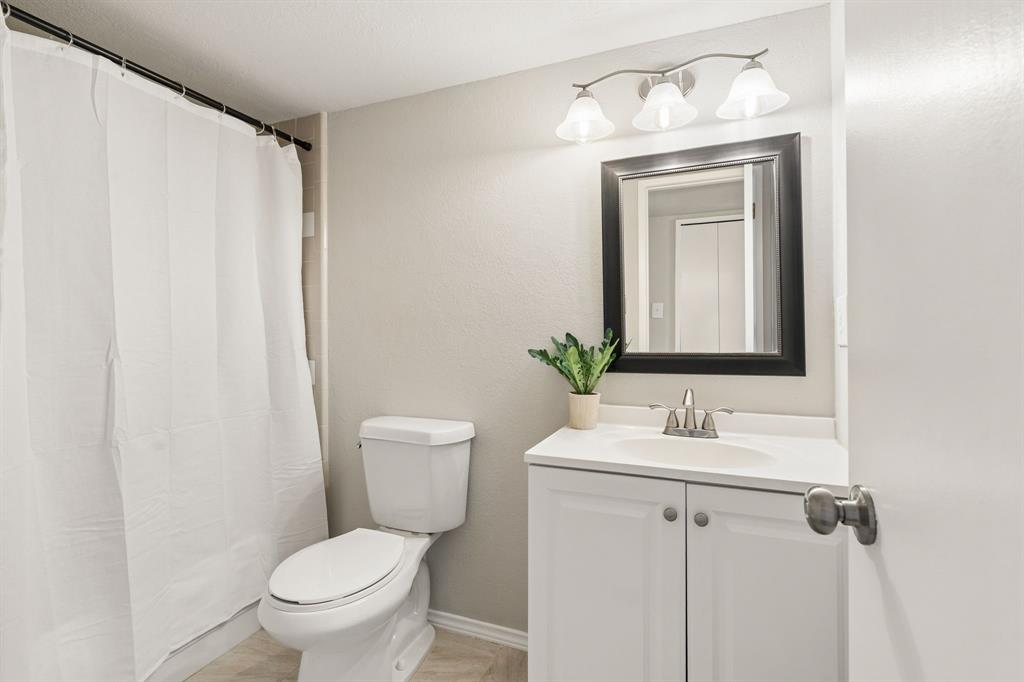 5620 Perrin Street The Colony, TX 75056 - Photo 20 of 31 a bathroom with a toilet sink and mirror