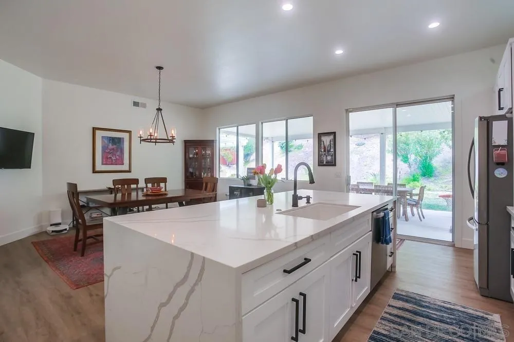 2322 Byron Place Carlsbad, CA 92008 - Photo 14 of 56 a kitchen with stainless steel appliances granite countertop a sink a stove and a refrigerator