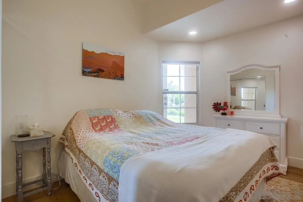 2322 Byron Place Carlsbad, CA 92008 - Photo 21 of 56 a bedroom with a bed and a mirror