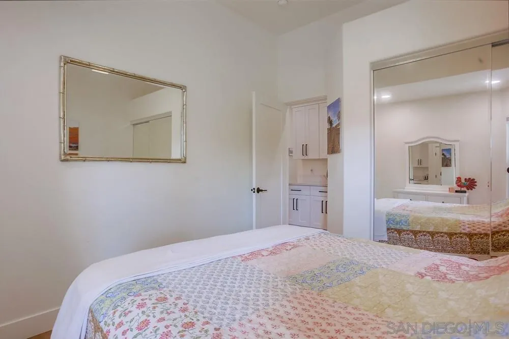 2322 Byron Place Carlsbad, CA 92008 - Photo 23 of 56 a bedroom with a bed and a mirror