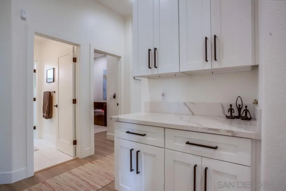 2322 Byron Place Carlsbad, CA 92008 - Photo 24 of 56 a kitchen with white cabinets and sink