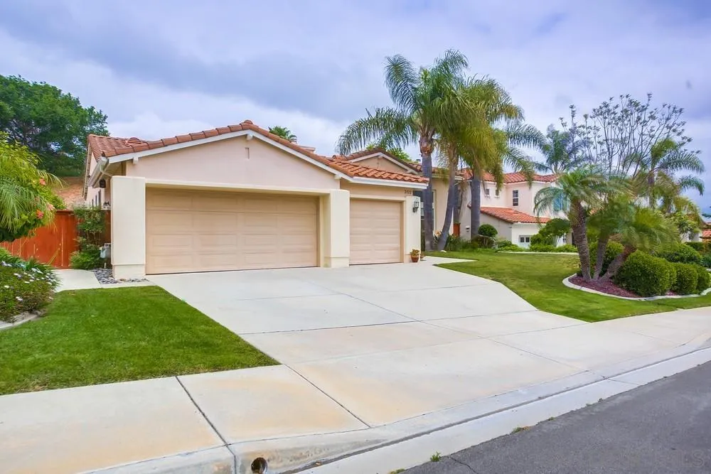 2322 Byron Place Carlsbad, CA 92008 - Photo 3 of 56 a front view of a house with a yard and a garage
