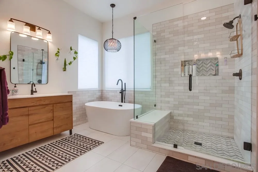 2322 Byron Place Carlsbad, CA 92008 - Photo 37 of 56 a spacious bathroom with a double vanity sink a large mirror and a shower