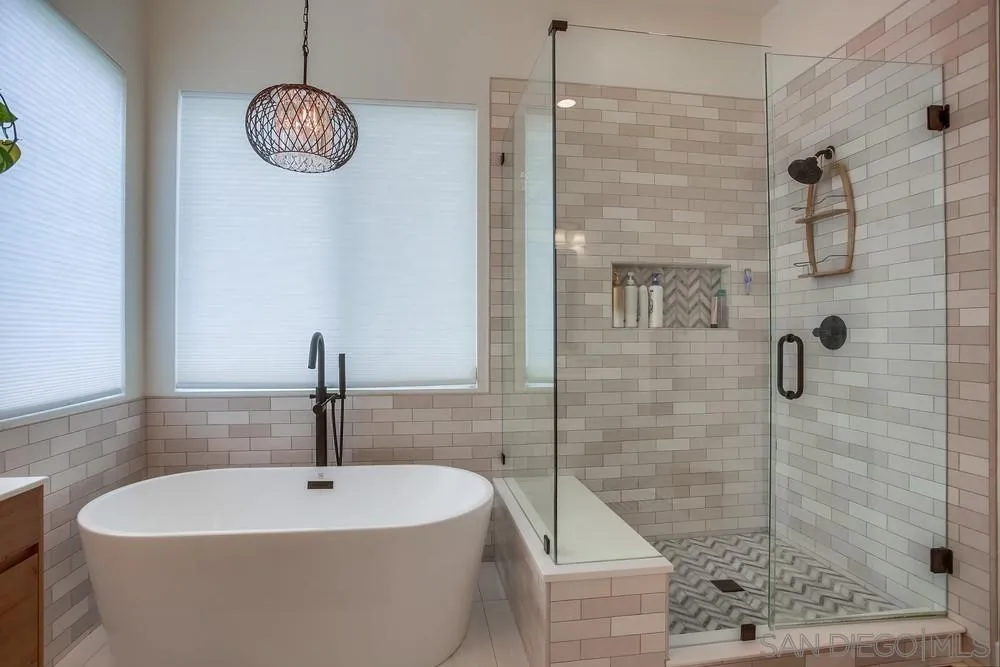 2322 Byron Place Carlsbad, CA 92008 - Photo 39 of 56 a bathroom with a sink a mirror and shower