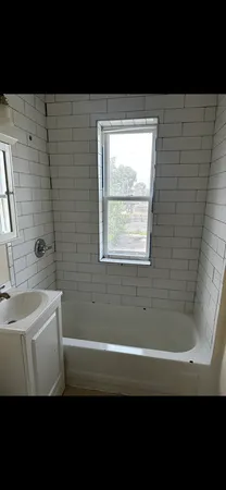 a bathroom with a sink a bathtub and a shower