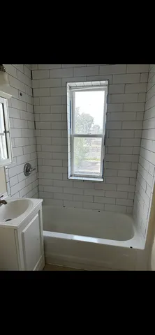 a bathroom with a sink a bathtub and a shower