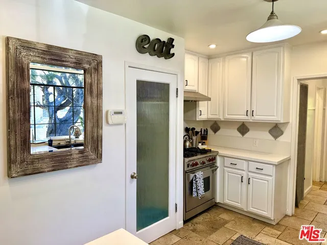a kitchen with a stove and a refrigerator