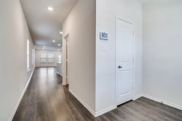 a view of hallway with wooden floor